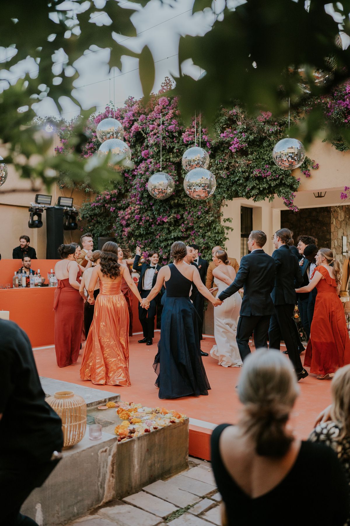 Wedding guests dancing outdoors under string lights at an elegant Arkansas reception